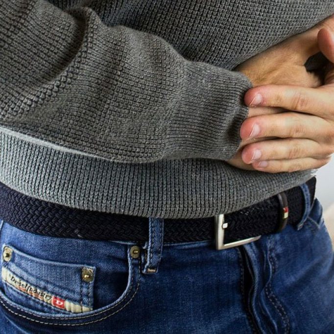 Delaware-Integrative-Medicine-Factory-Holding-Stomach-Sick-802x541