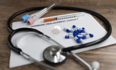 Doctors desk with Hormone Replacement Therapy related items.  Stethoscope, paperwork and prescription medications.